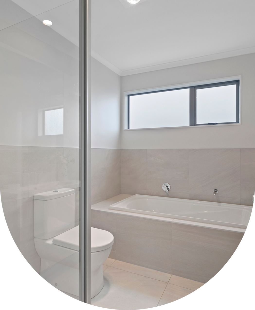 Modern bathroom with bathtub and toilet.