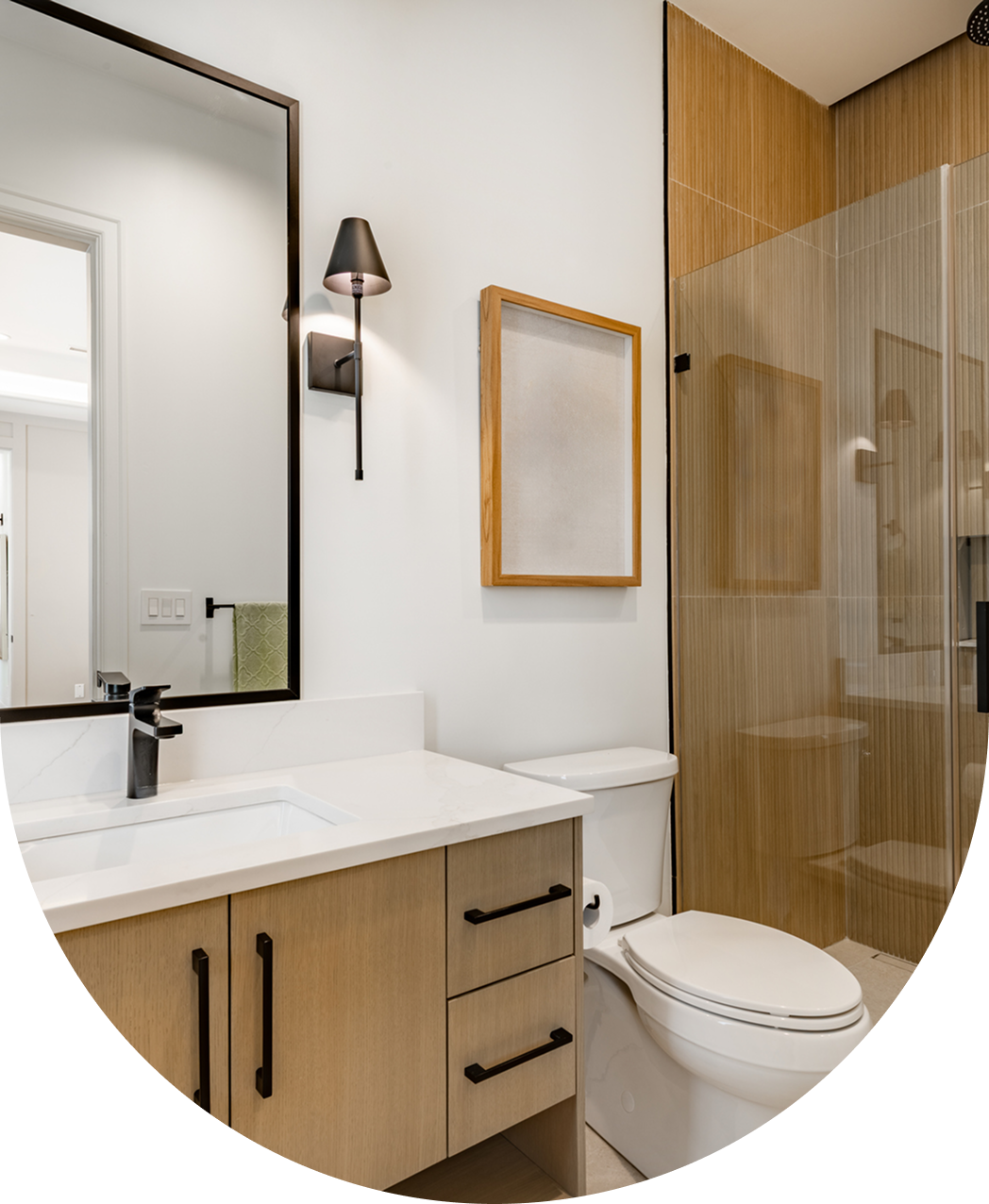Modern bathroom with wooden accents and mirror.